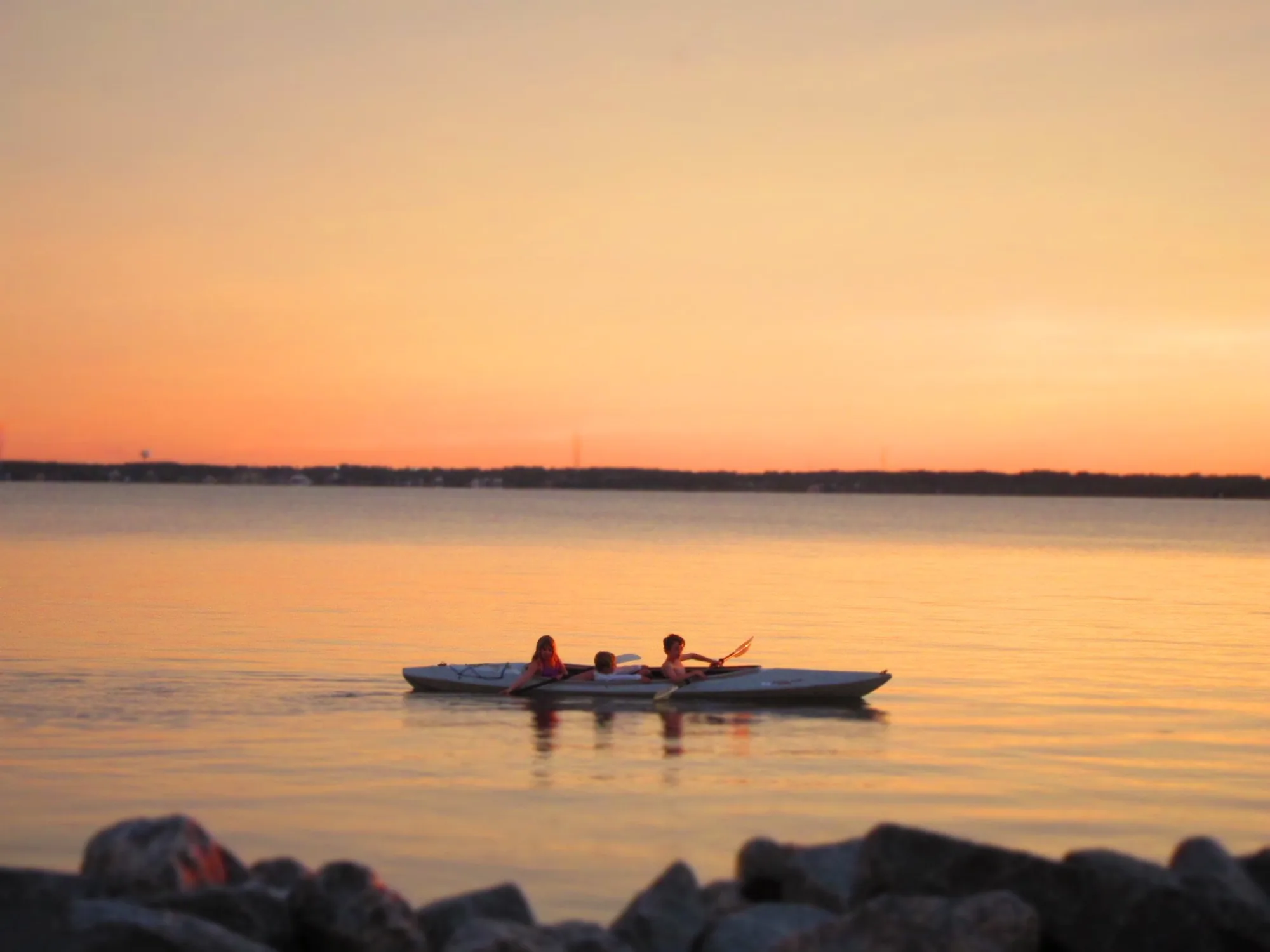 Kids kayaking at sunset