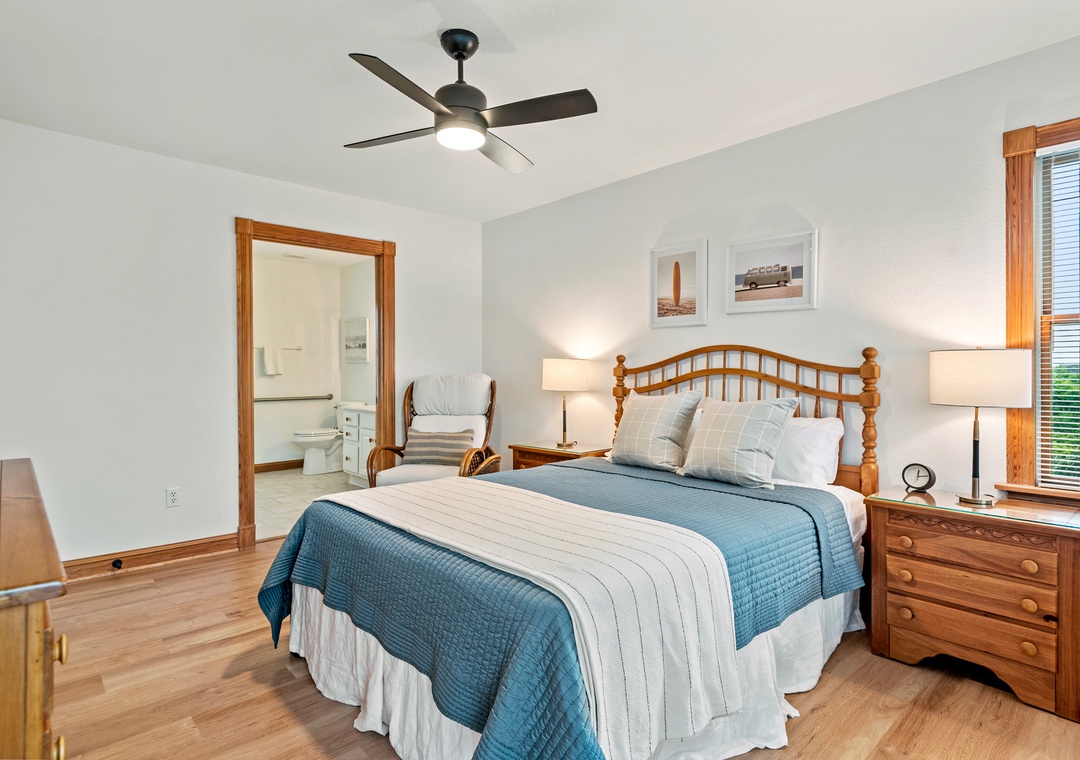 Queen bedroom with blue quilt and ensuite bath