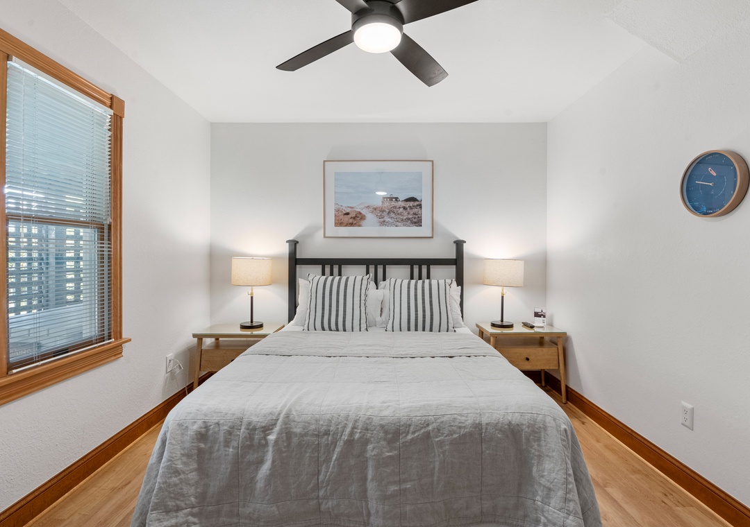 Guest bedroom with striped pillows and coastal art